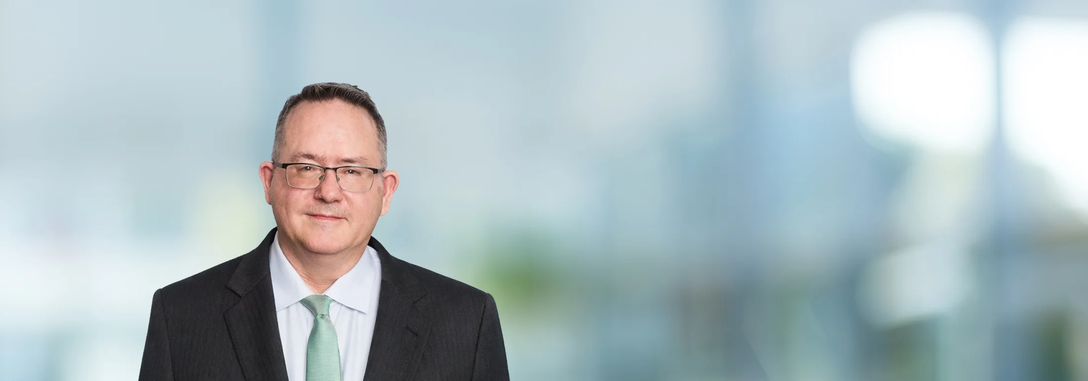 A photo of attorney Steven Dargitz against a softly blurred office background
