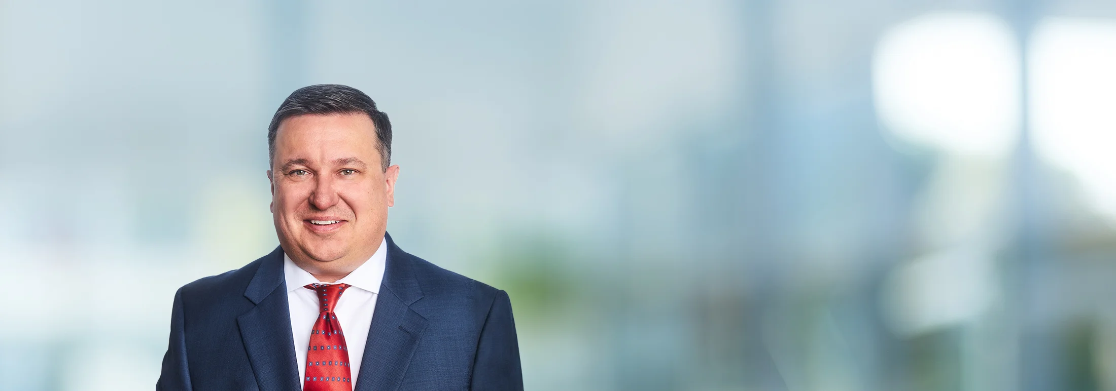 A photo of attorney Patrick Furlong against a softly blurred office background