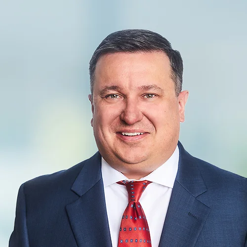 A photo of attorney Patrick Furlong against a softly blurred office background