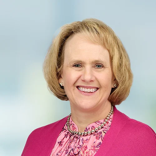 A photo of attorney Jackie Gallagher against a softly blurred office background