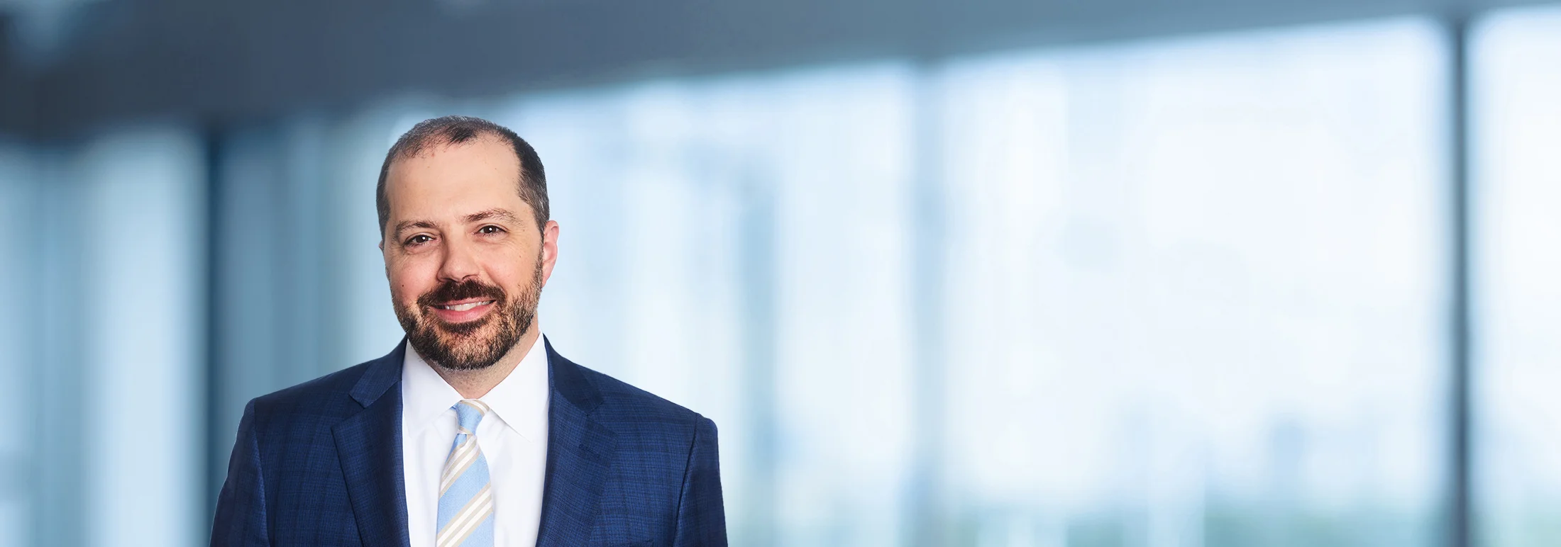 A photo of attorney Kevin Golden against a softly blurred office background