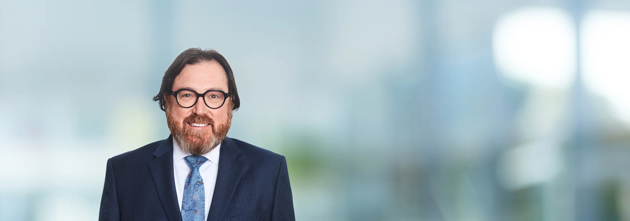 A photo of attorney Peter Kulp against a softly blurred office background
