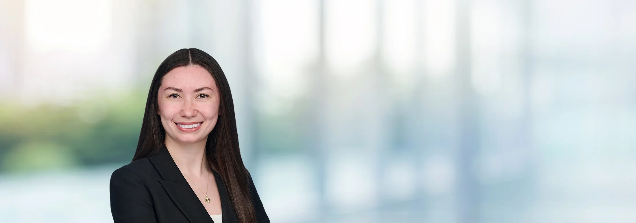 A photo of attorney Rebecca Love against a softly blurred office background
