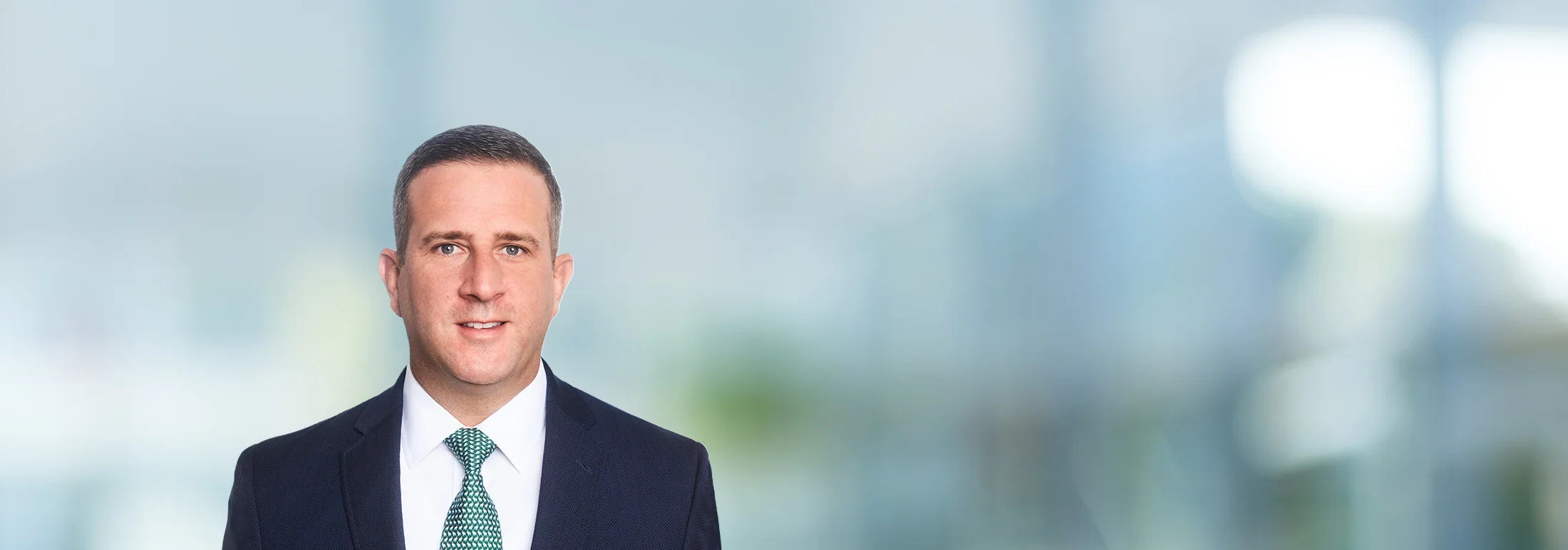 A photo of attorney Drew Mallick against a softly blurred office background