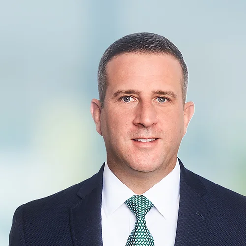 A photo of attorney Drew Mallick against a softly blurred office background