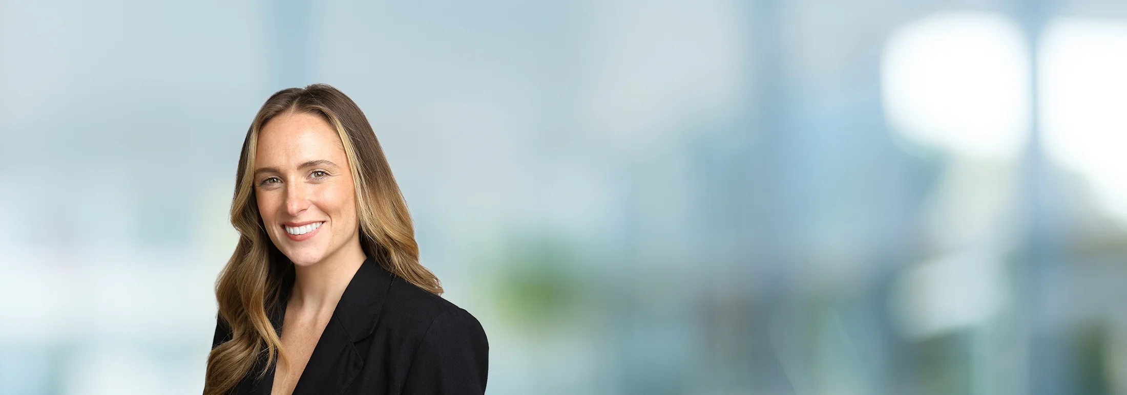 A photo of attorney Kathryn McCallion against a softly blurred office background