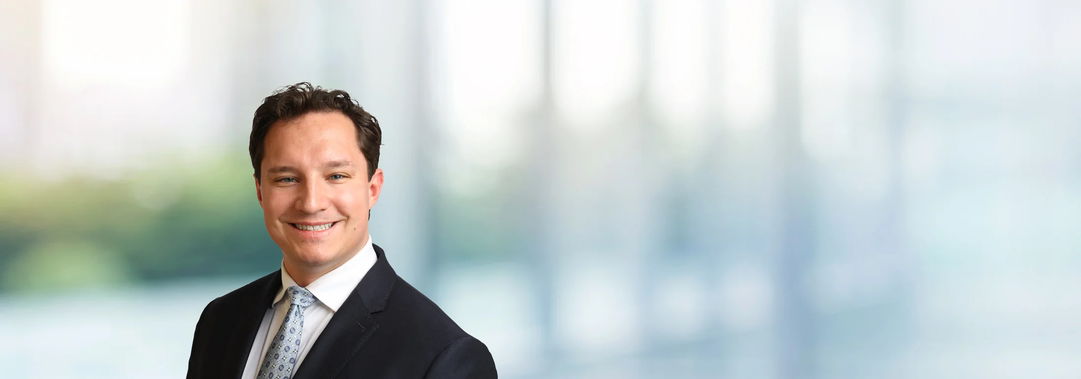 A photo of attorney Ruslan Murphy against a softly blurred office background