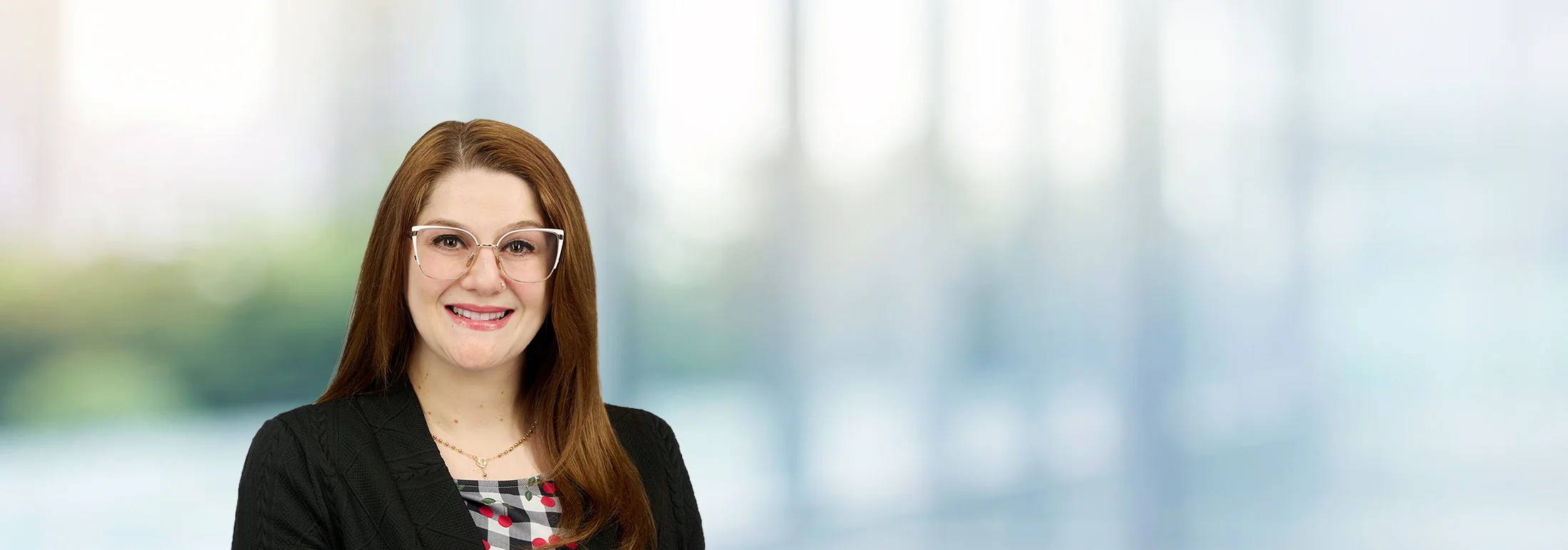 A photo of attorney Samantha Percoraio against a softly blurred office background