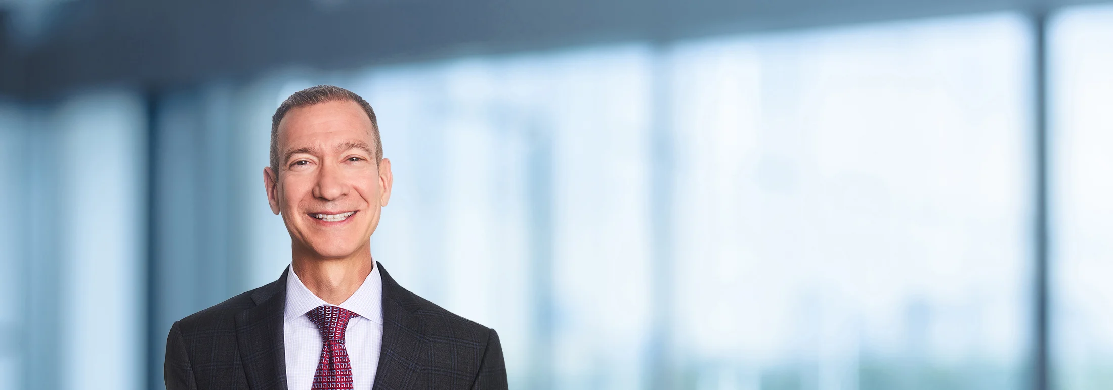 A photo of attorney Mike Sweeney against a softly blurred office background