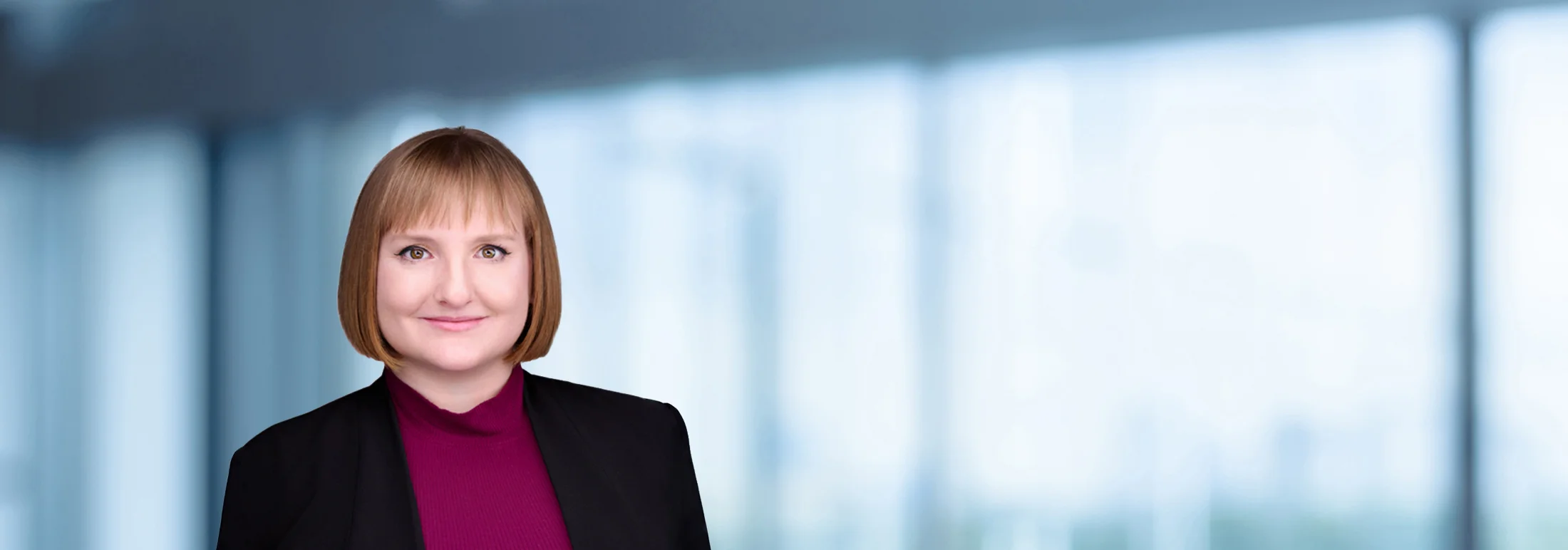 A photo of attorney Alexandra Boyer against a softly blurred office background