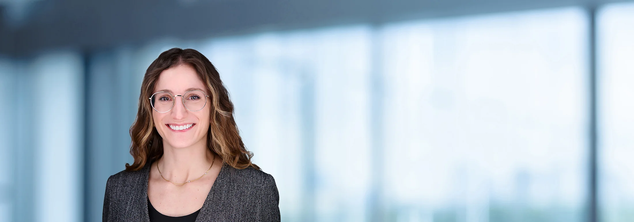 A photo of attorney Gabrielle Conti against a softly blurred office background