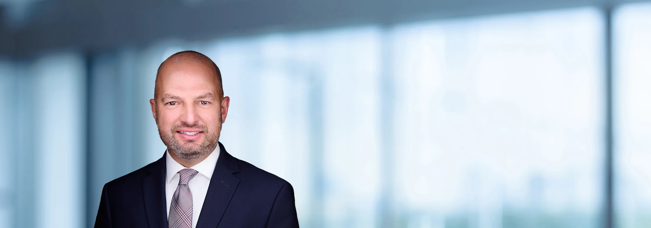A photo of attorney Dean Falavolito against a softly blurred office background