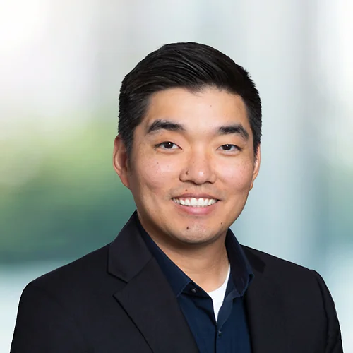 A photo of attorney Andrew Cho against a softly blurred office background