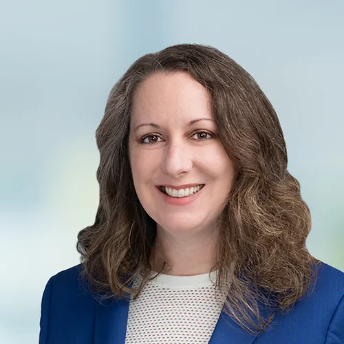 A photo of attorney Alyson Decker against a softly blurred office background