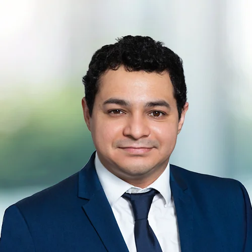 A photo of attorney Eduardo Dominguez against a softly blurred office background