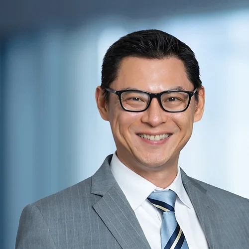 A photo of attorney Jier Dong against a softly blurred office background