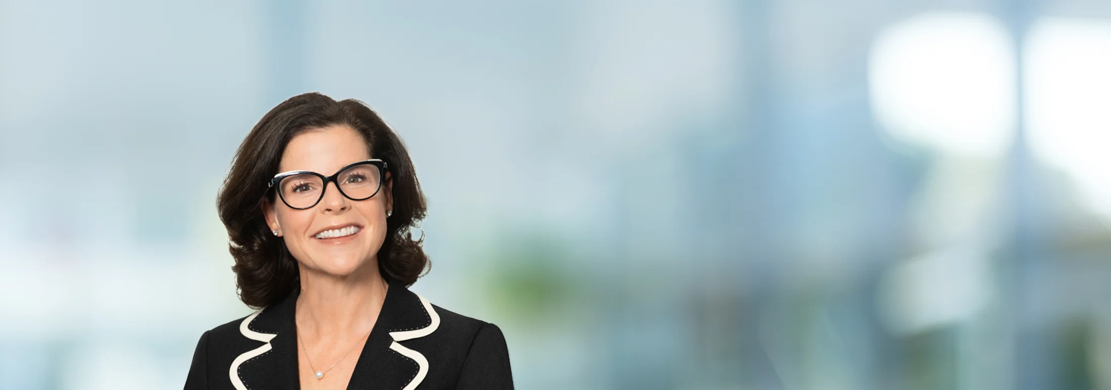 A photo of attorney Sarah Goldstein against a softly blurred office background