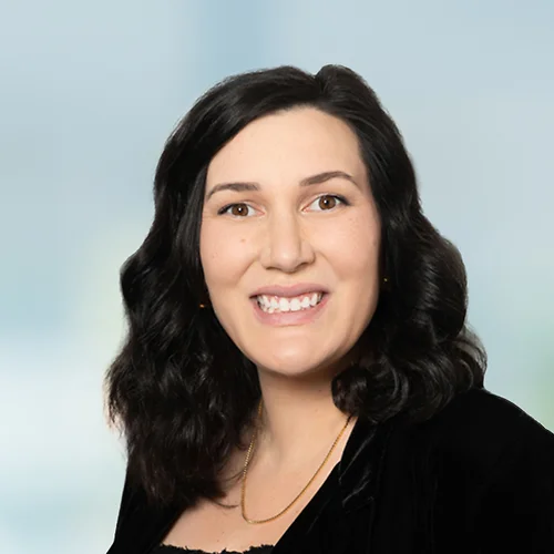 A photo of attorney Marilena Guadagnini against a softly blurred office background