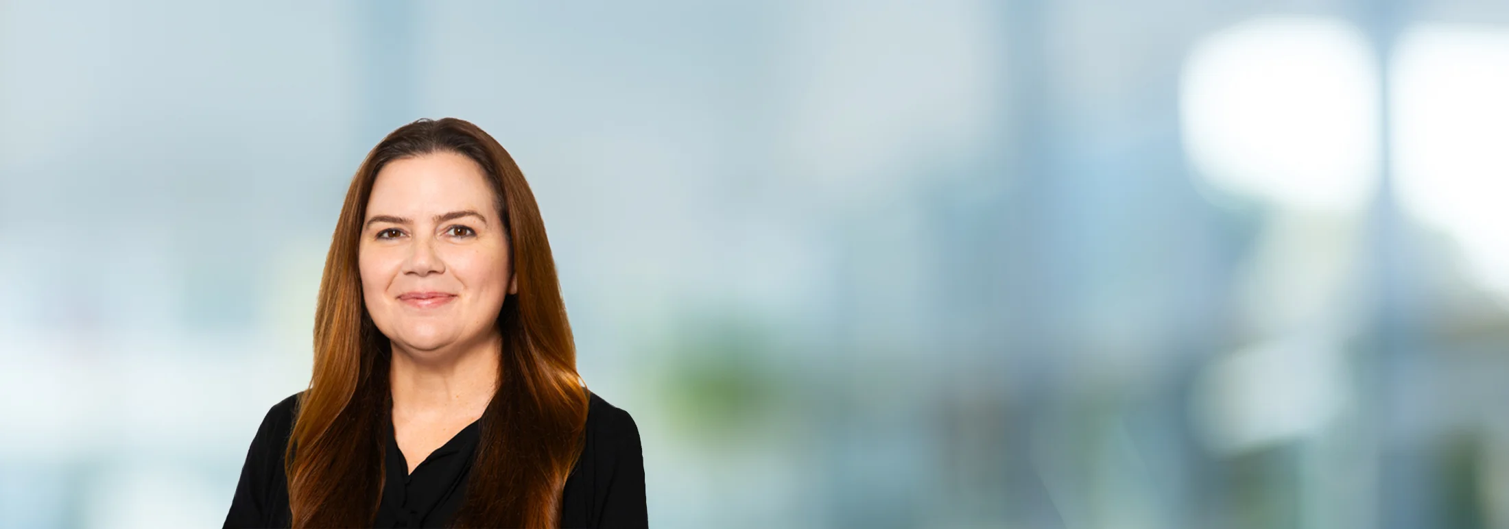 A photo of attorney, Christina Guerin, against a softly blurred office background