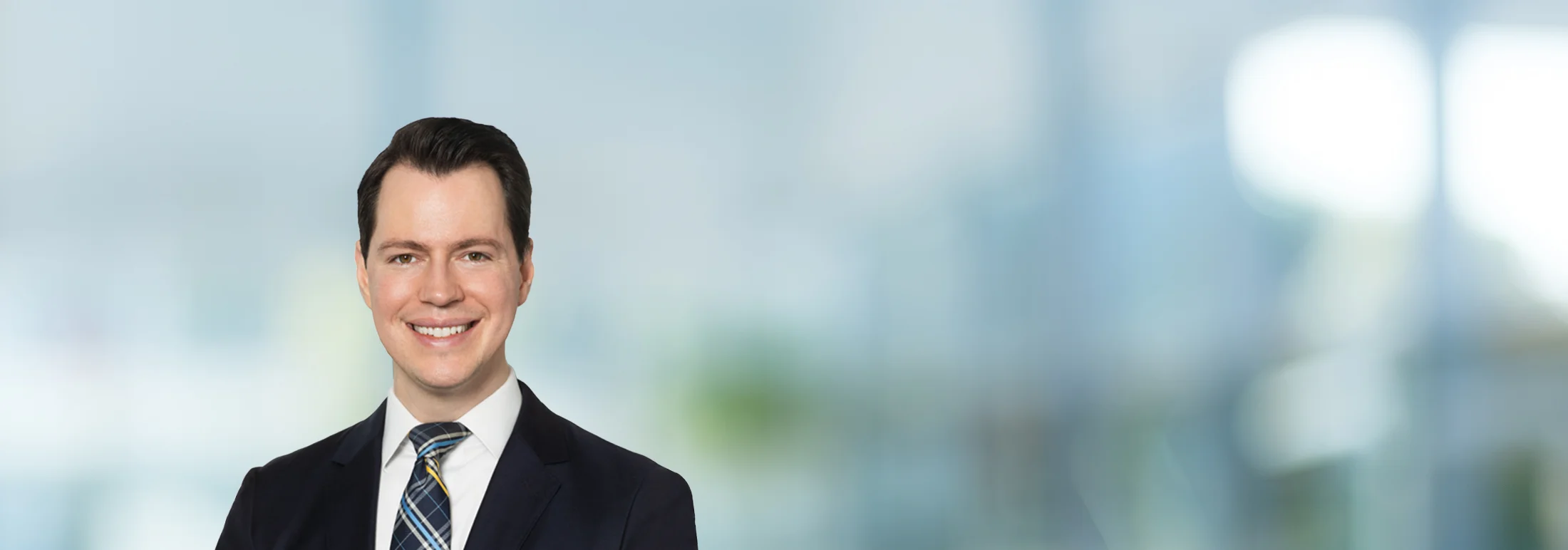 A photo of attorney Alexander Hawgood against a softly blurred office background
