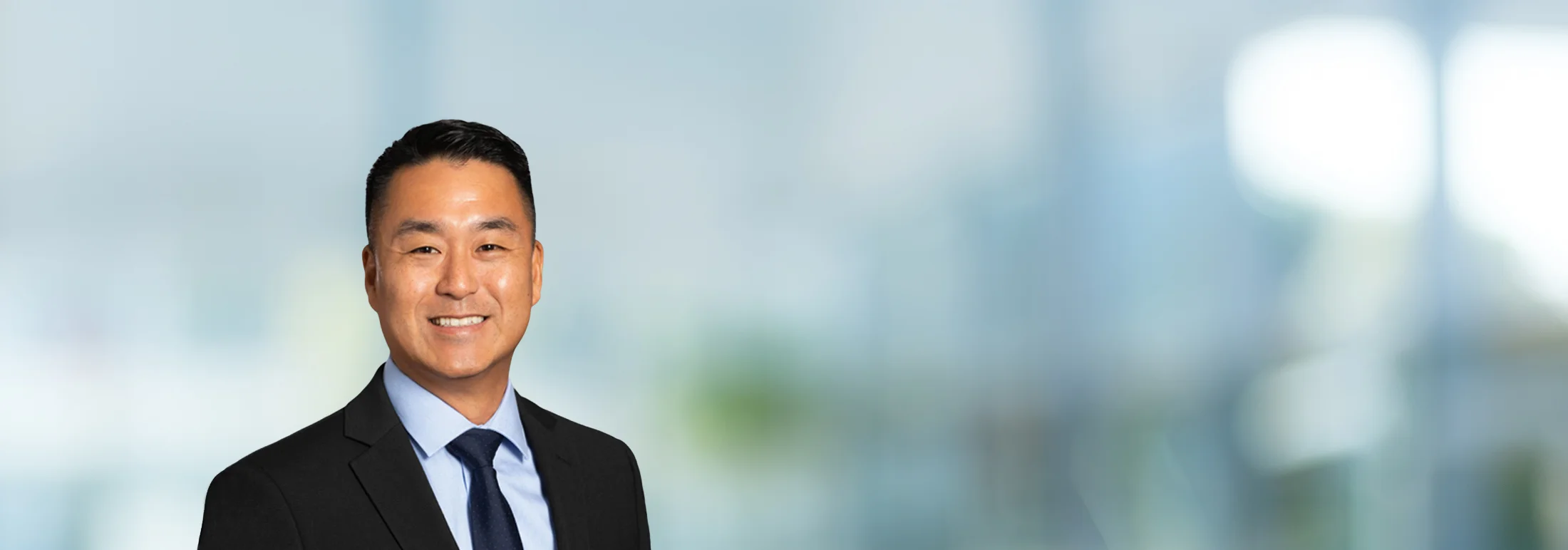 A photo of attorney Jai Hong Kim against a softly blurred office background