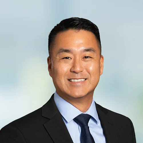 A photo of attorney Jai Hong Kim against a softly blurred office background