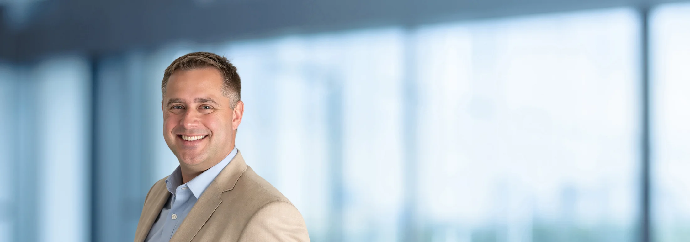A photo of attorney Peter Lewicki against a softly blurred office background