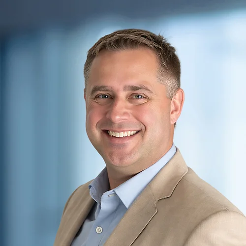 A photo of attorney Peter Lewicki against a softly blurred office background
