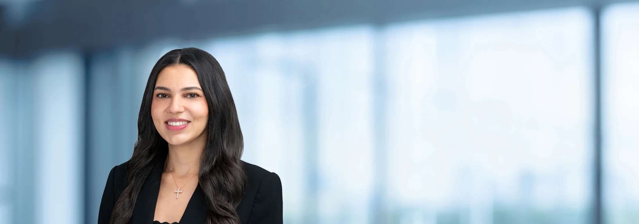 A photo of attorney Monica Mishriki against a softly blurred office background