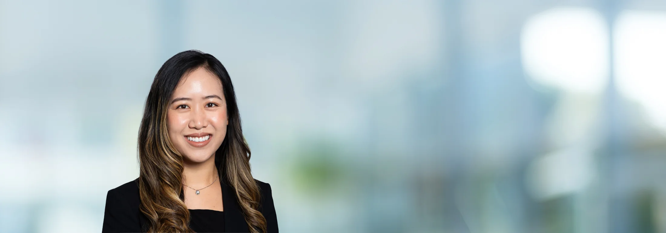 A photo of attorney Kimberly Mucchiani against a softly blurred office background