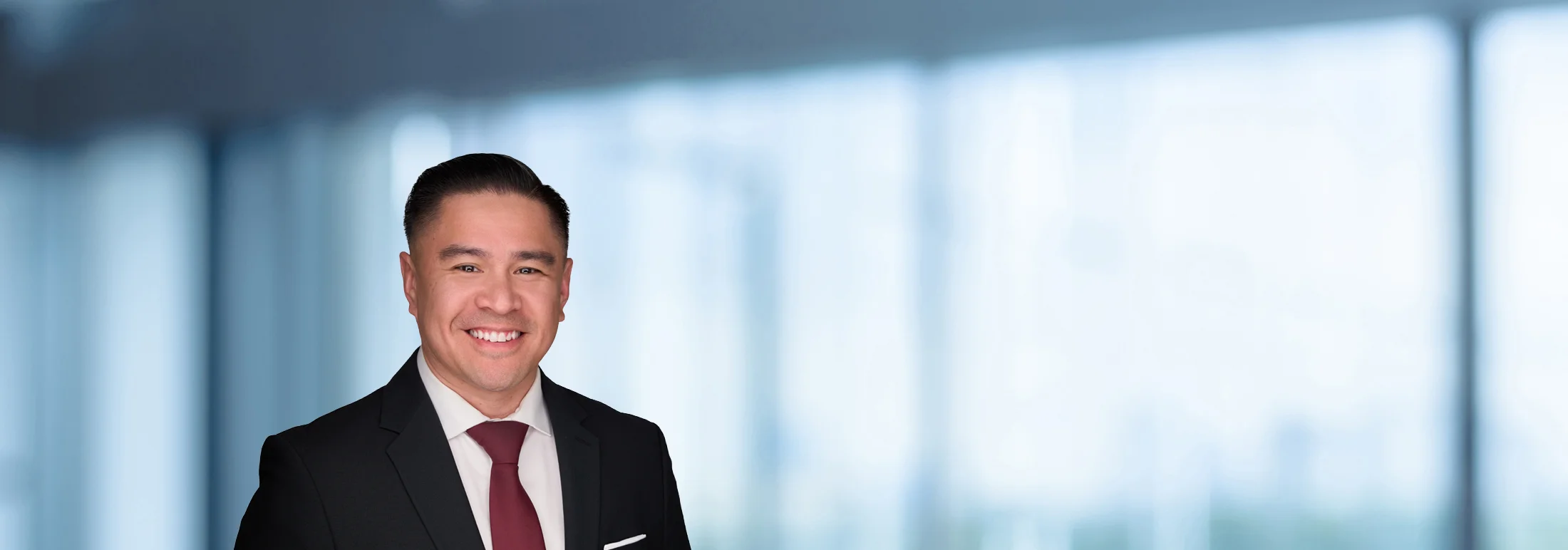 A photo of attorney, Chris Nepacena, against a softly blurred office background