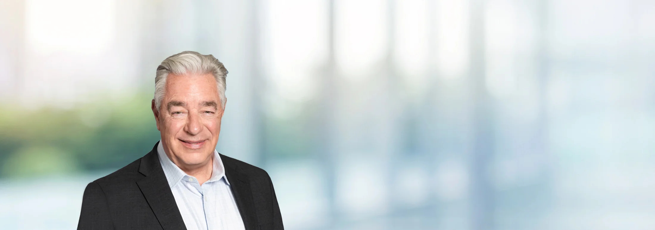 A photo of attorney, David Nusz, against a softly blurred office background