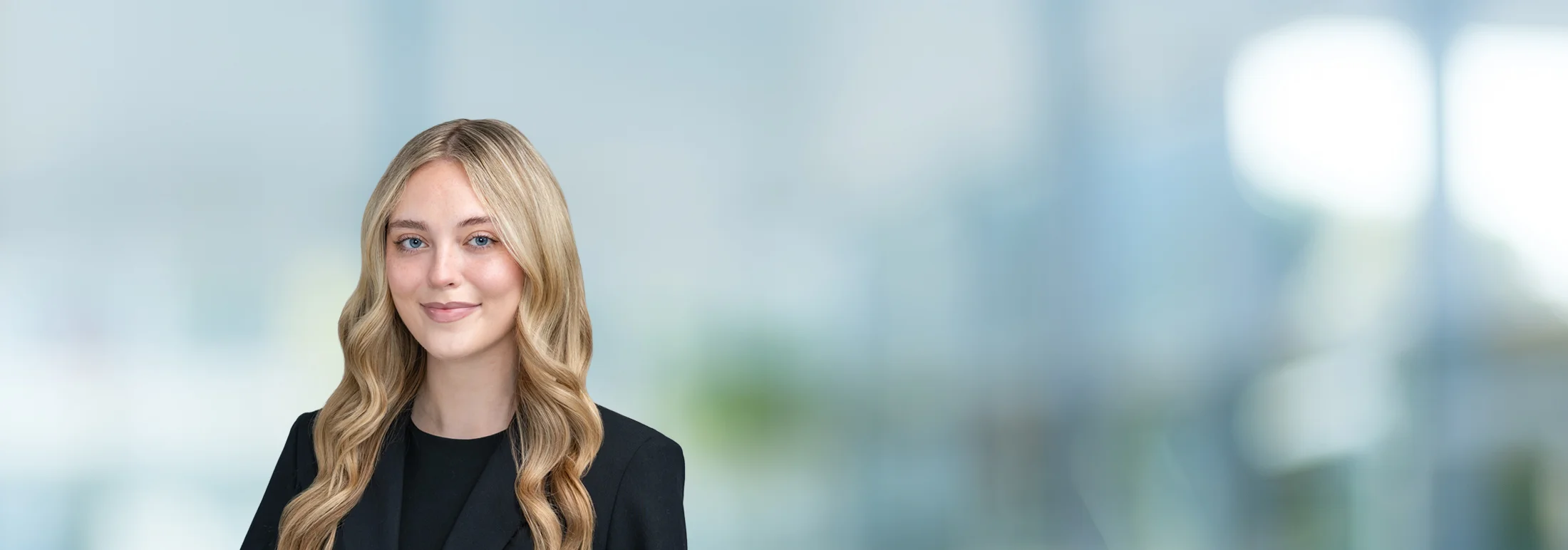A photo of attorney Madison O'Neill against a softly blurred office background