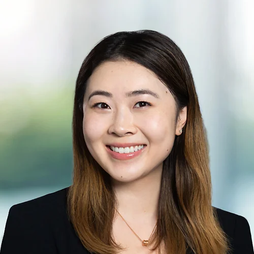 A photo of attorney Amy Qi against a softly blurred office background