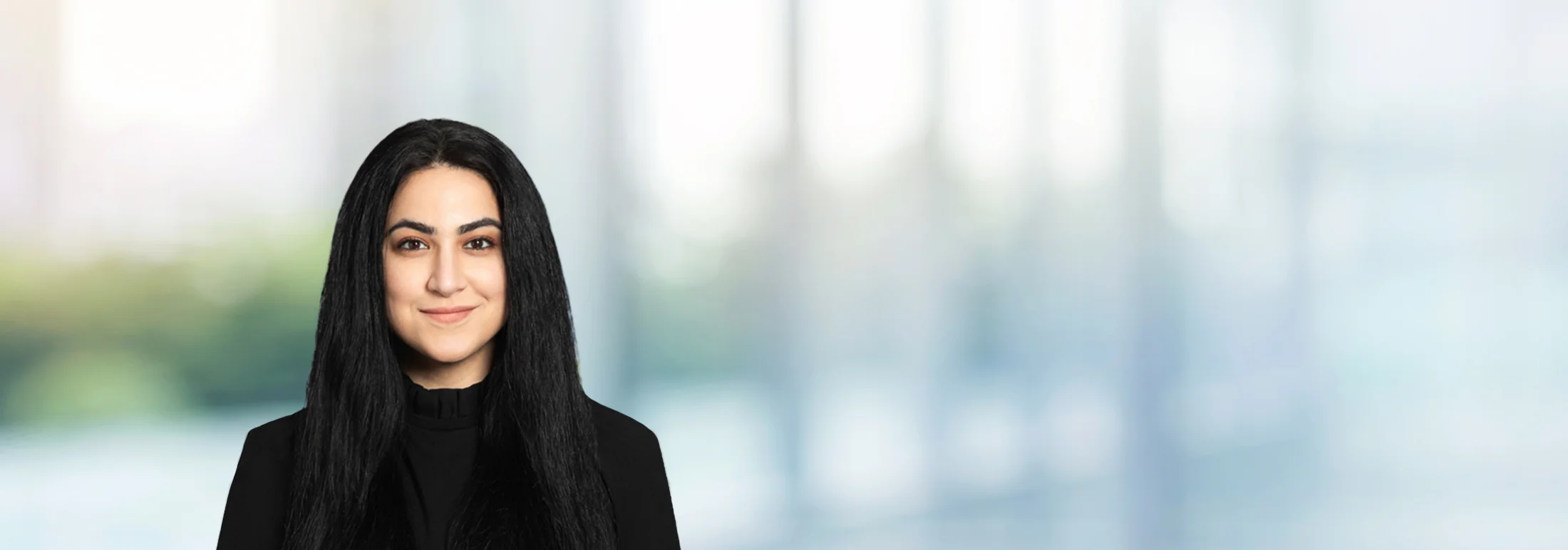 A photo of attorney Pardis Saleki against a softly blurred office background