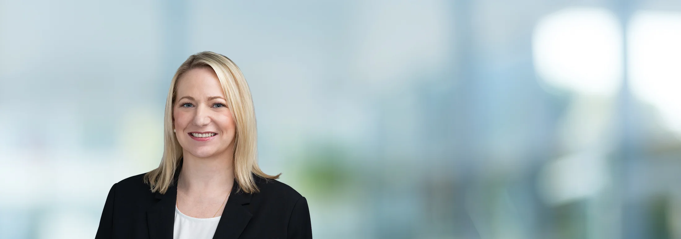 A photo of attorney Jessica Thompson against a softly blurred office background
