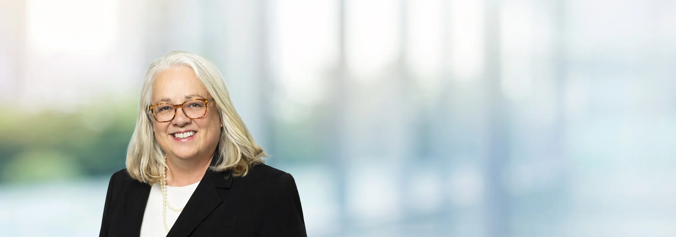 A photo of attorney Rebecca Wilson against a softly blurred office background