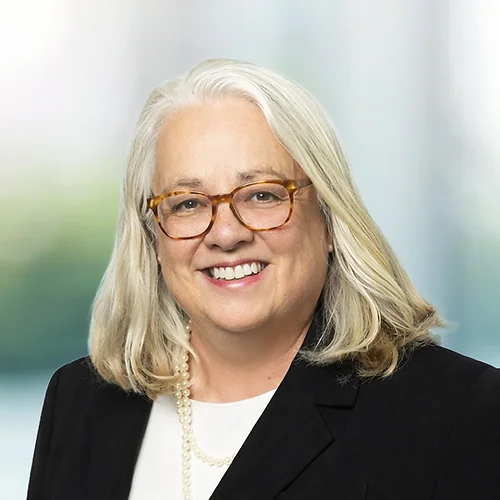 A photo of attorney Rebecca Wilson against a softly blurred office background