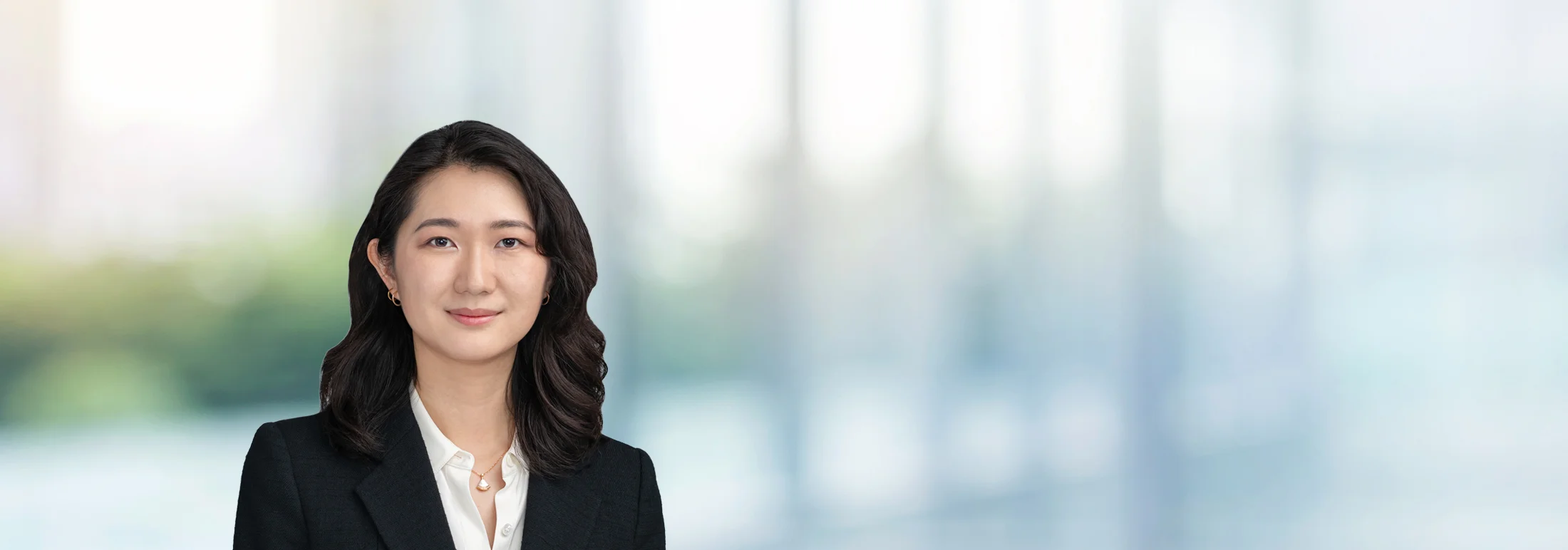 A photo of attorney Millicent Wong against a softly blurred office background