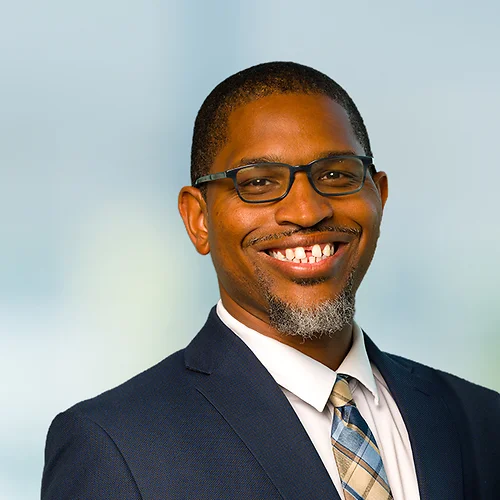 A photo of attorney, Michael Pierce, against a softly blurred office background