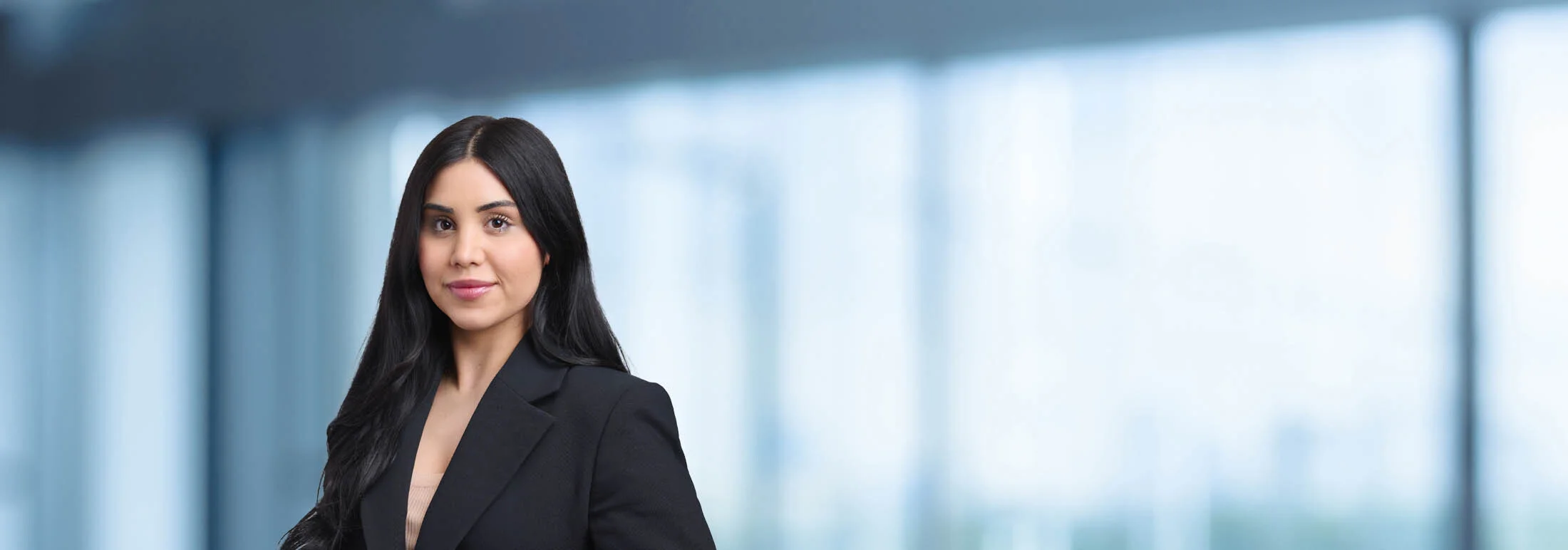 A photo of attorney Katrina Akbarian against a softly blurred office background