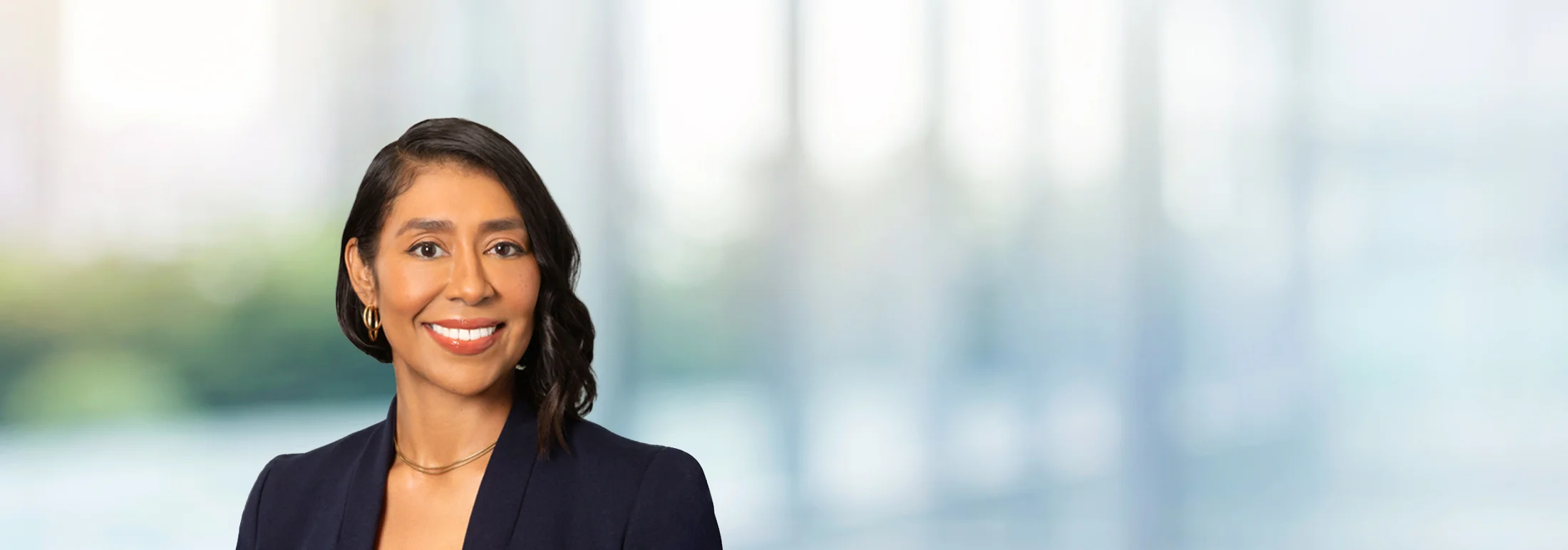 A photo of attorney Kandice Canchan against a softly blurred office background