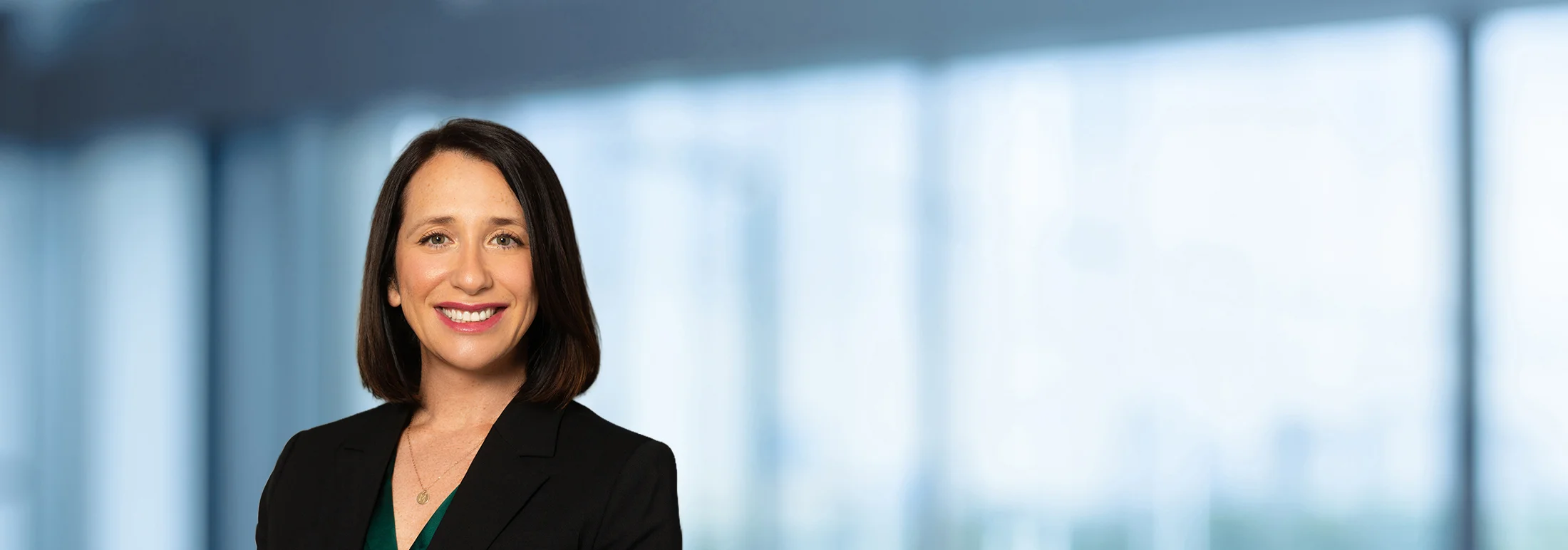A photo of attorney, Megan Childress, against a softly blurred office background