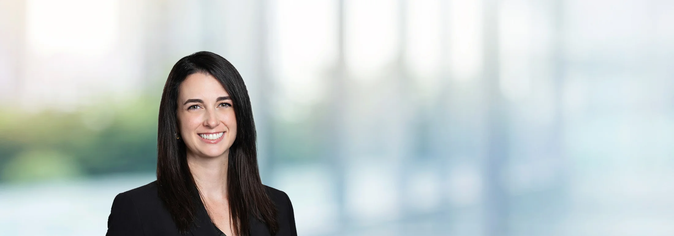 A photo of attorney Victoria Danna against a softly blurred office background