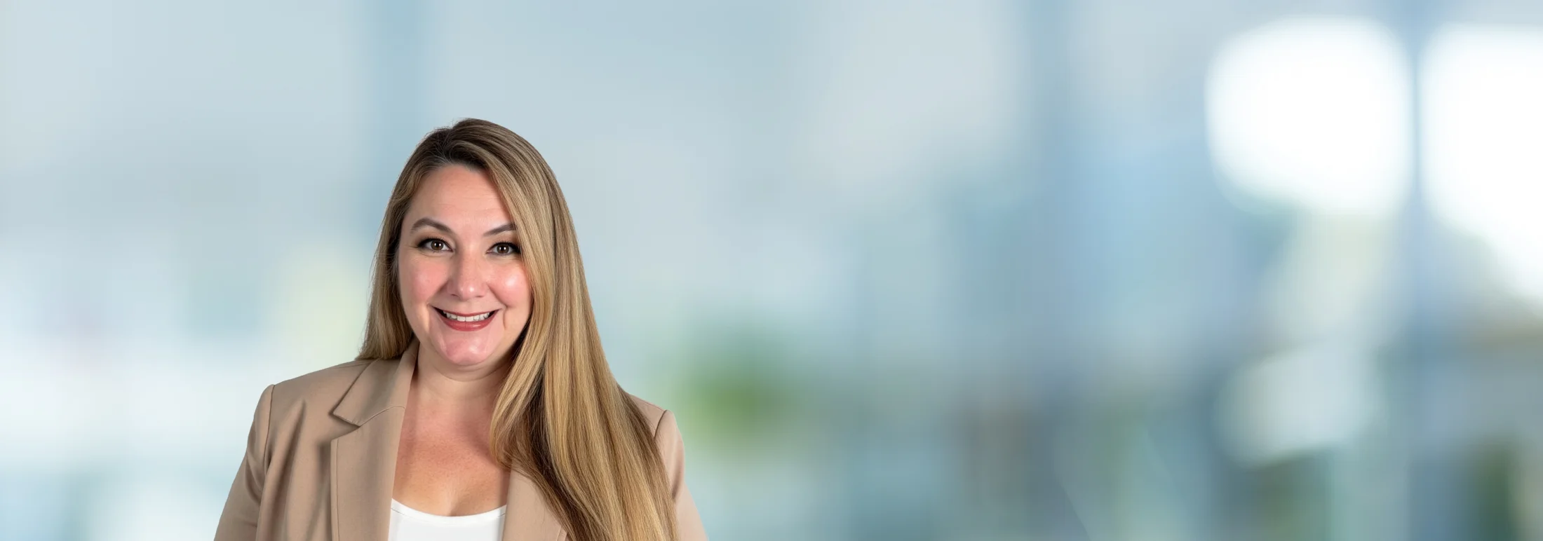 A photo of attorney, Alyson M. Dudkowski, against a softly blurred office background