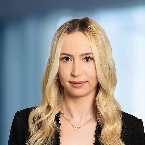 A photo of attorney Irene Gharapet against a softly blurred office background