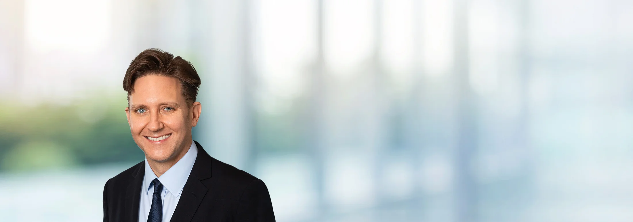 A photo of attorney John Haubrich against a softly blurred office background