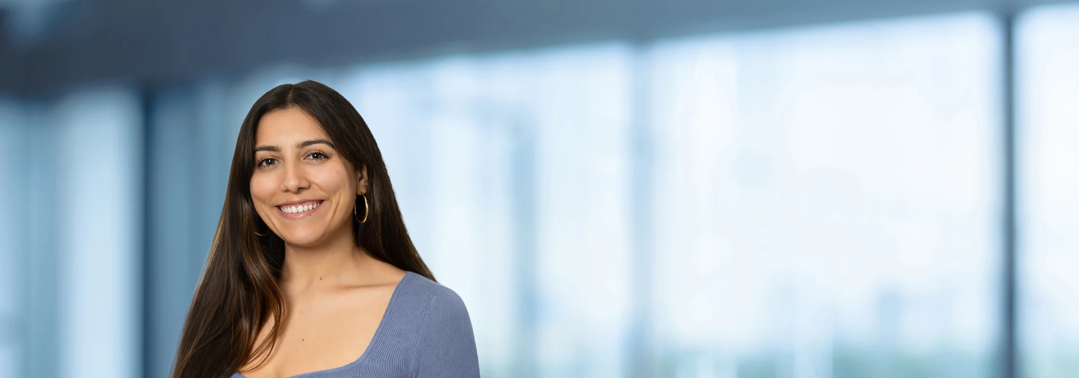 A photo of attorney Andrea Hernando against a softly blurred office background