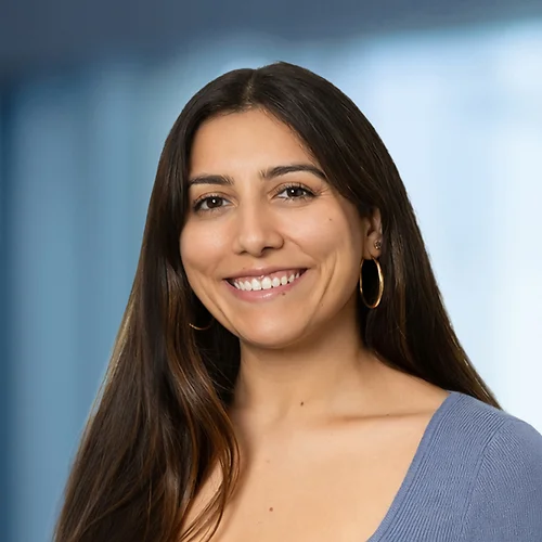 A photo of attorney Andrea Hernando against a softly blurred office background