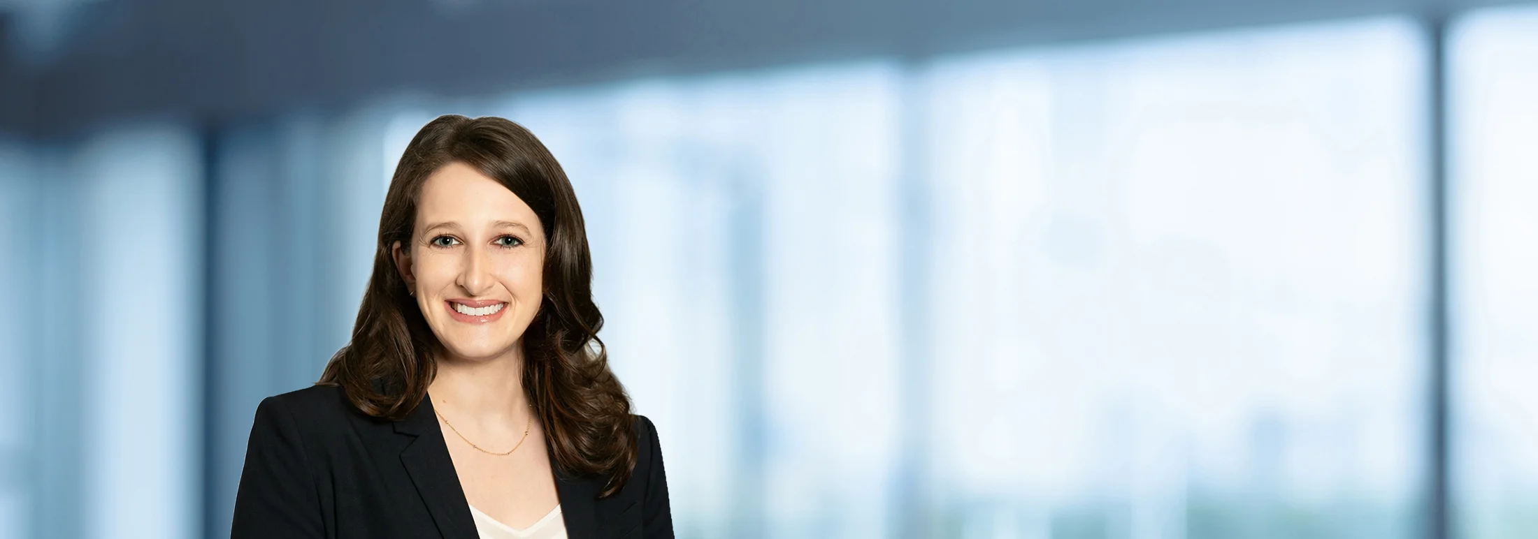 A photo of attorney Ashleigh Kasper against a softly blurred office background